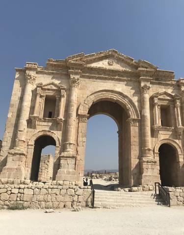 Ancient stone archway in bright sunlight.
