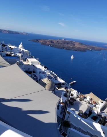Aerial view of white buildings on cliffs over the sea.