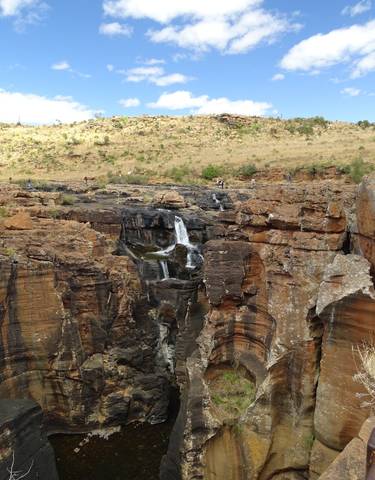 A waterfall surrounded by rugged rock formations.