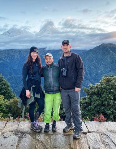 Tourists with a guide on a mountain peak.