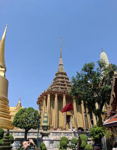 Ornate traditional architecture with a spire against a clear blue sky.