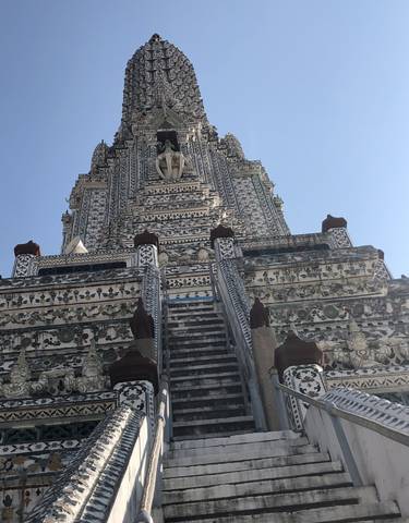 Intricately decorated temple tower under a clear sky.