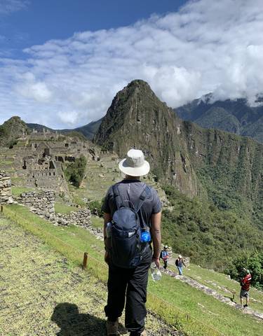 Person standing with a view of Machu Picchu
