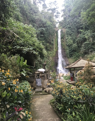 Waterfall with traditional Indonesian structures