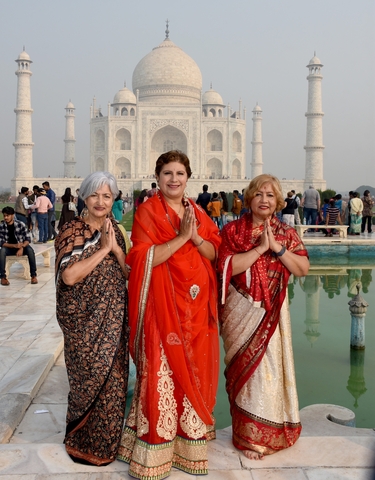 Three women posing in front of the Taj Mahal