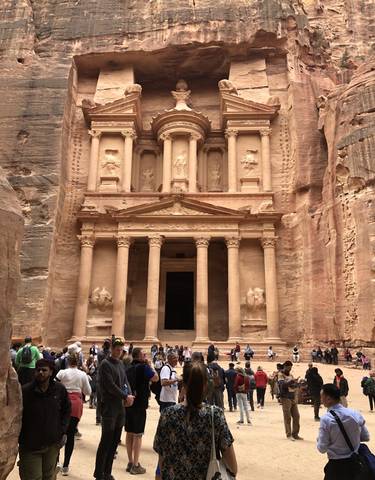 The facade of a grand ancient building carved into rock.