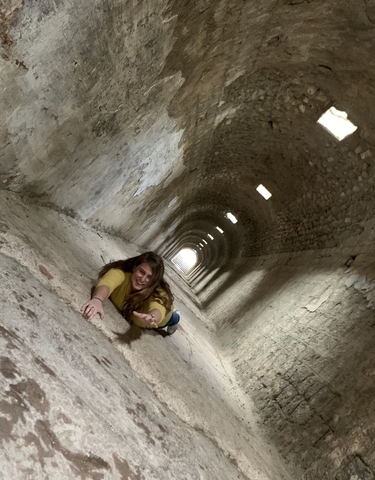 Woman in a tunnel looking forward dramatically.