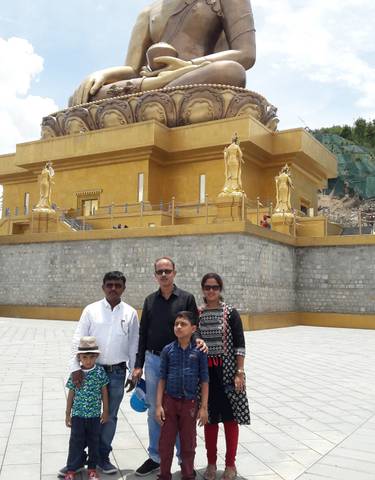 Family posing in front of a golden building.