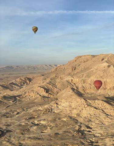 Hot air balloon over a desert landscape.