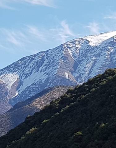 Snow-capped mountain peaks with clear blue sky.