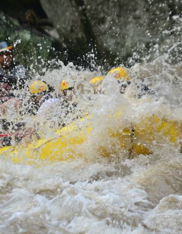 Group whitewater rafting in turbulent water.