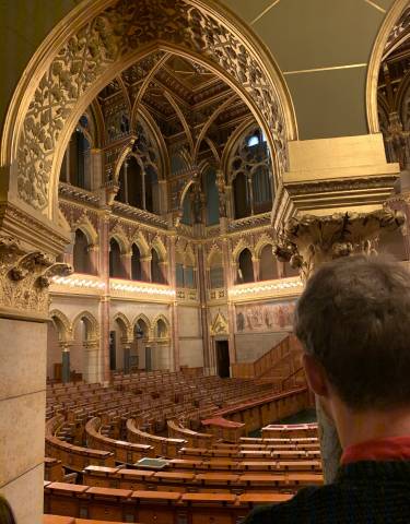 Ornate interior of a classical building with gold accents.