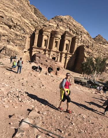 People exploring a historic sandstone monument.