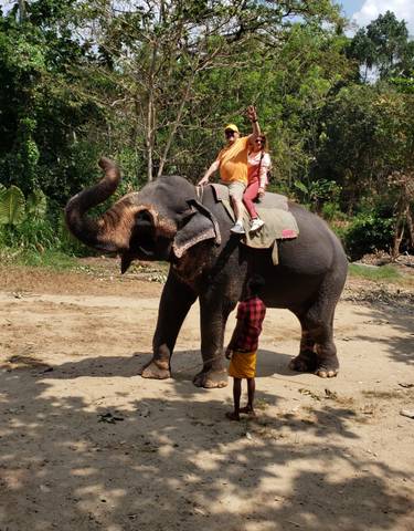 Couple riding an elephant.
