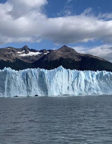 Glacier with mountain backdrop.