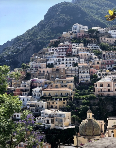 Colorful cliffside village with stacked houses.