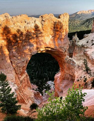 Natural stone arch with surrounding canyon.