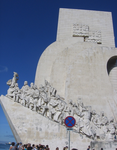 Monument with statues on a carved stone wall.