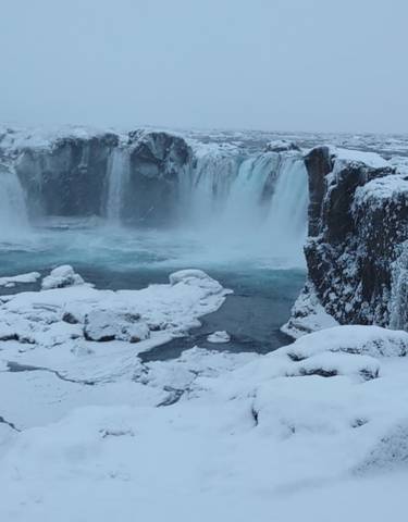 Waterfall surrounded by snow and ice