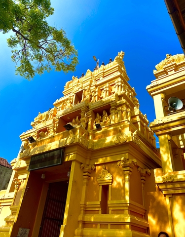 Golden temple under a clear blue sky.