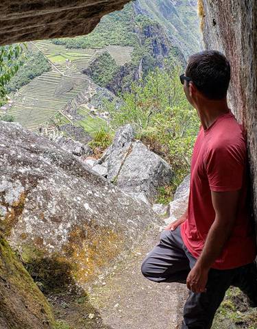 Man looking at Machu Picchu from a viewpoint.