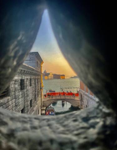 A canal in Venice viewed through a narrow gap.