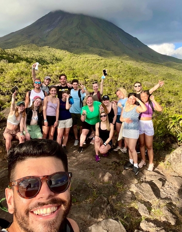 A group of people posing on a hiking trip.
