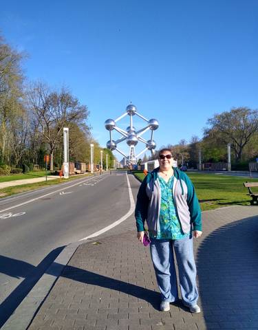 Person standing in front of the Atomium monument in Brussels.