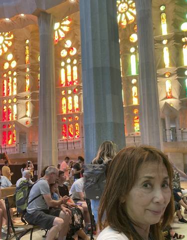 Interior view of a colorful cathedral with people.