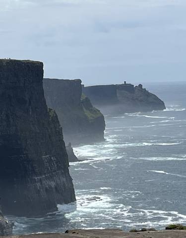 Cliffs on a misty day overlooking the ocean.