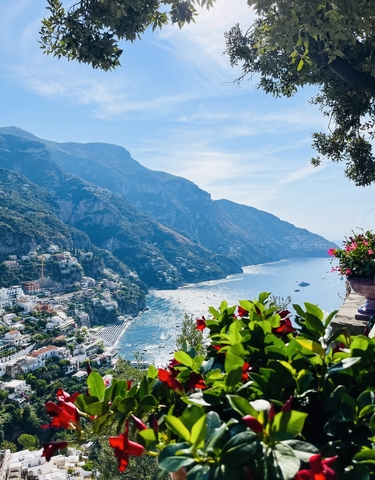 Aerial view of a coastal city with mountains and the sea.