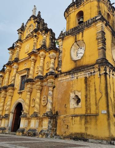 A historic yellow church with ornate details.