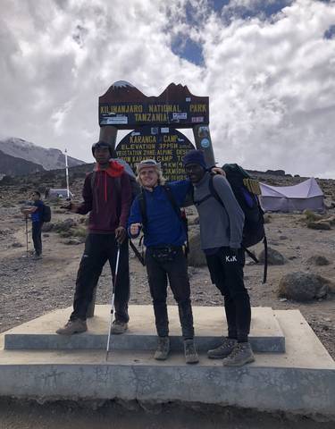 Three hikers at a mountain camp.