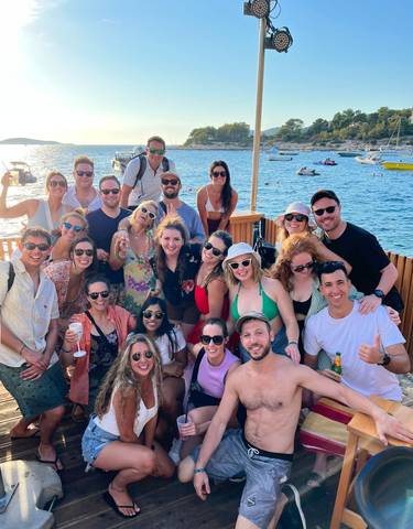 Large group of people enjoying a boat party.