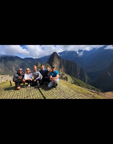 Group of people posing at Machu Picchu.