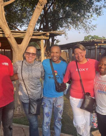 Group of people posing outdoors.