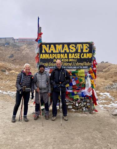 Group at Annapurna Base Camp with a welcome sign.