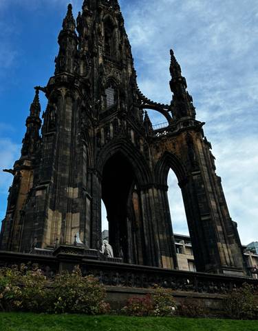 Towering Scott Monument with dramatic arches against the blue sky.