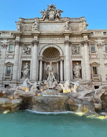 Trevi Fountain with statues and glowing water.