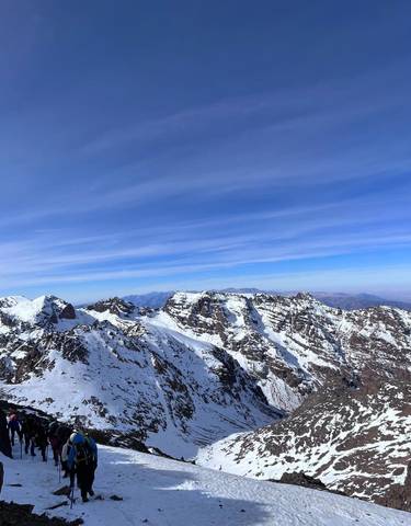 Snow-covered mountain peaks under a clear blue sky.