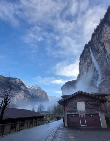 Waterfall cascading from a tall rocky cliff.