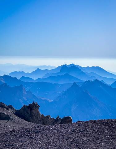 Layers of distant mountain ranges in varying shades of blue.