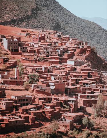 Clustered red clay buildings on a hillside.