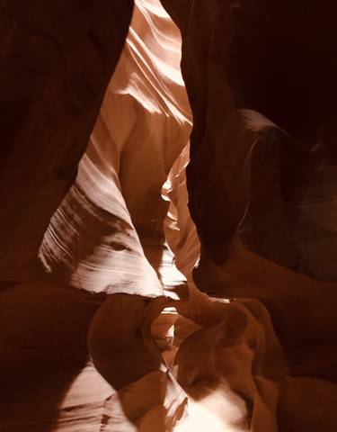 Antelope Canyon with sunlight filtering through the rock formations.