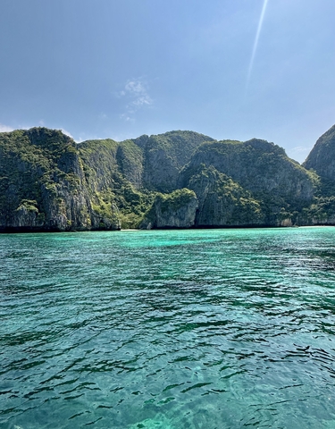 Scenic view of turquoise waters with steep cliffs.
