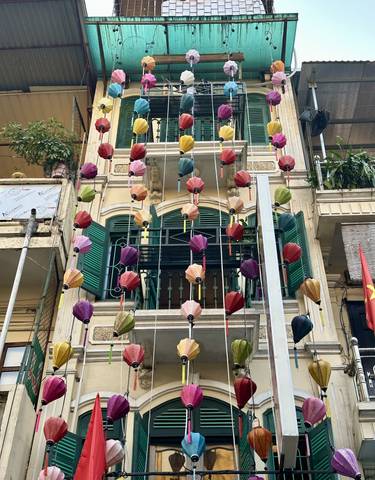 A building facade decorated with colorful hanging lanterns.