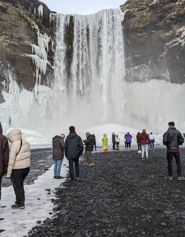 Tourists at a frozen waterfall