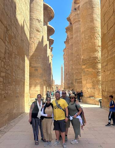 Group of people standing in an ancient Egyptian temple.