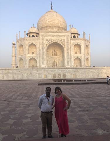 Two people posing in front of the Taj Mahal.