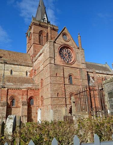 Historical stone building with a large window.